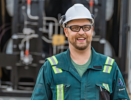 a man in safety gear smiling.