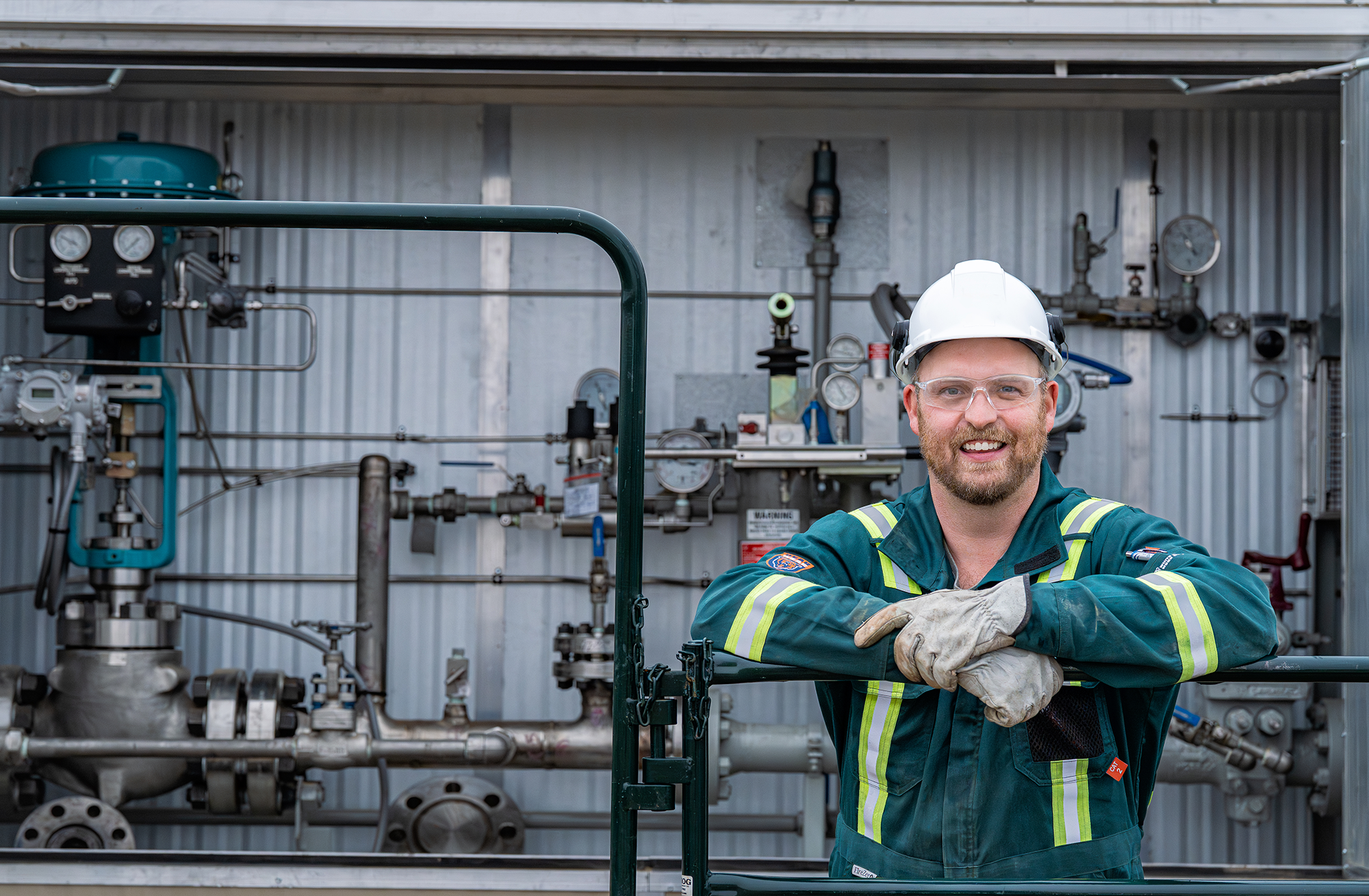 a man wearing safety gear and smiling.